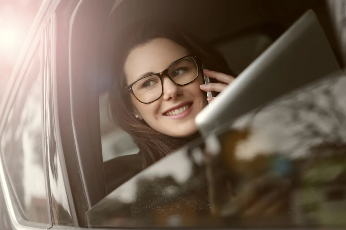 Driver on the phone in a car getting an SR22 insurance quote